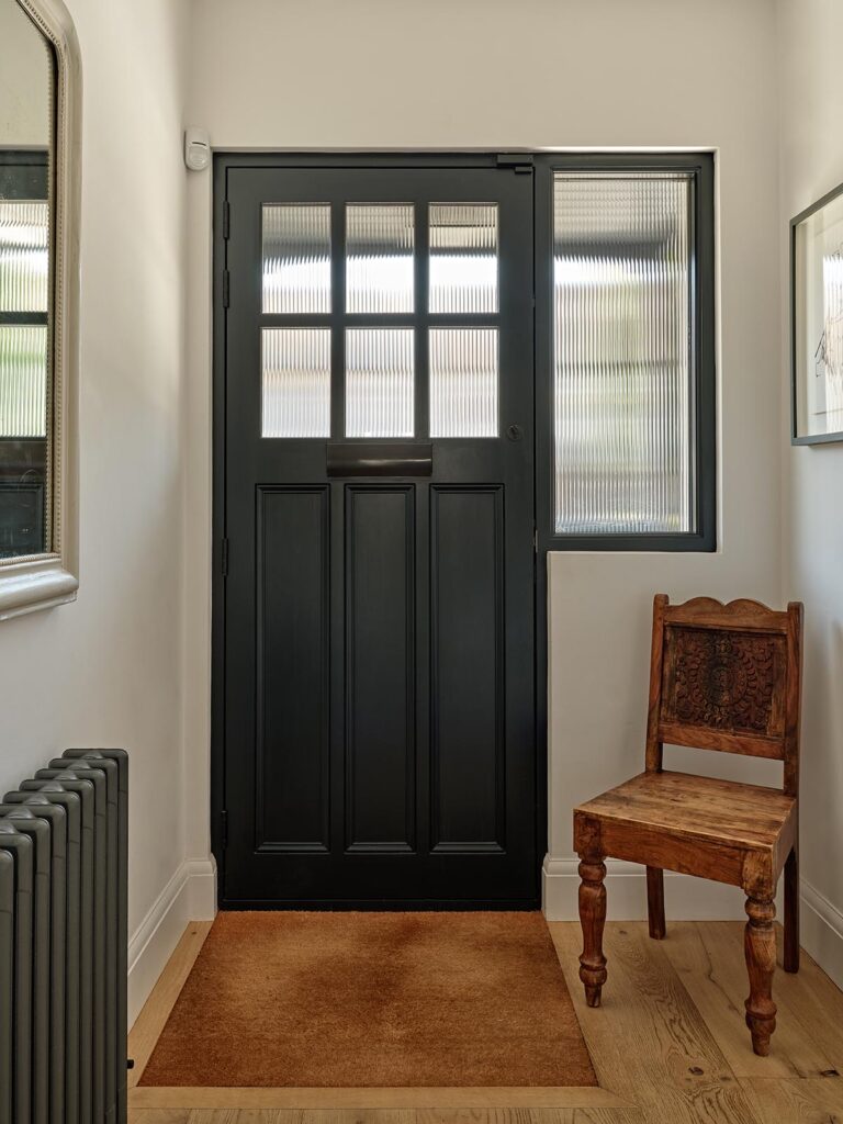 a timber front door with reeded glass