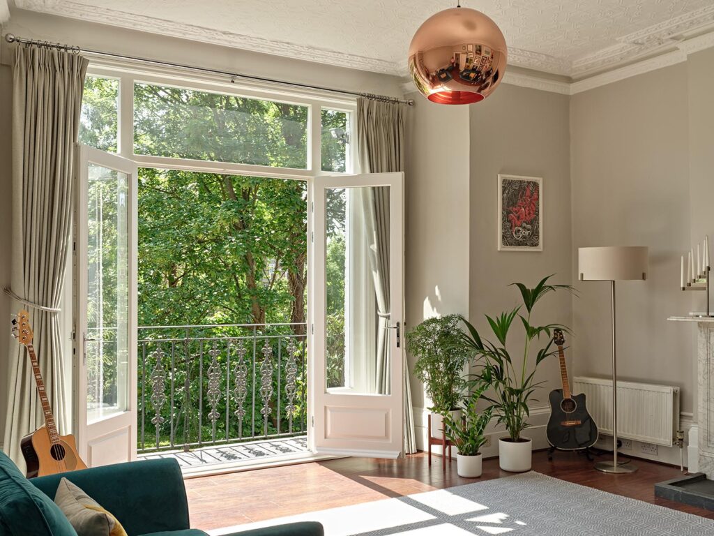 Timber French doors open with a balcony