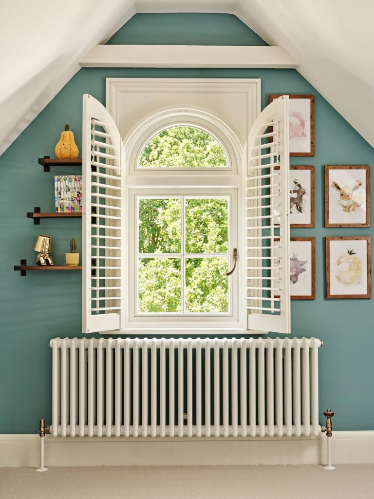 a timber casement window with blue walls and a radiator below
