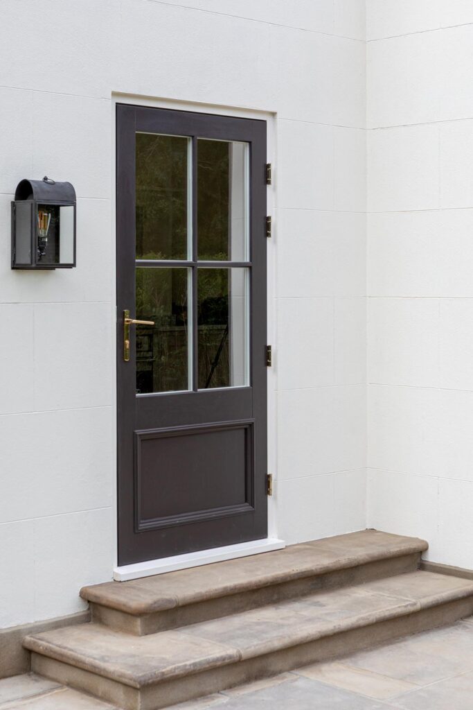 A timber rear door with beading beading and polish brass