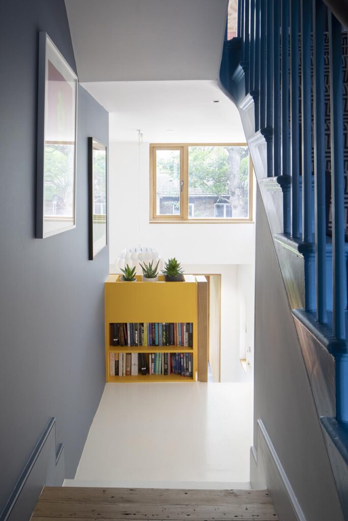 An oak frame casement window at the bottom of some stairs