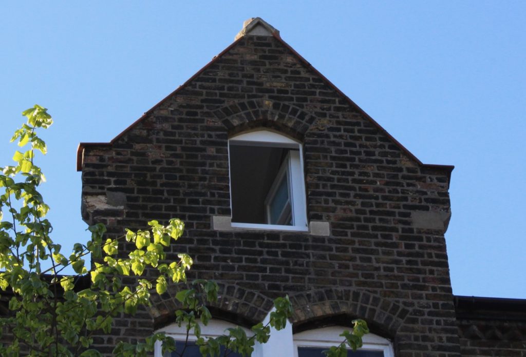 brick building in Hampstead with top window open