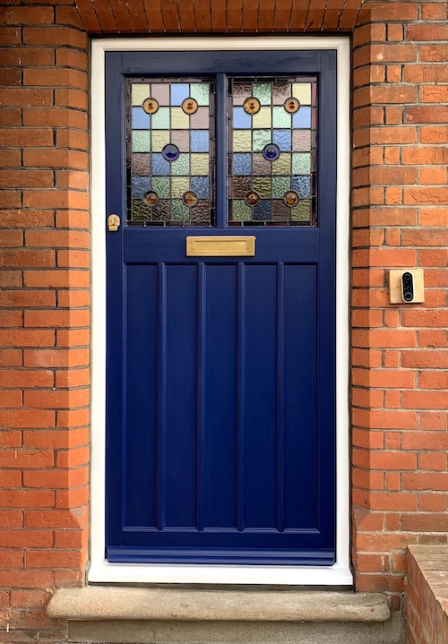 Wooden front door with hand made stained glass