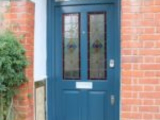 blue entrance door with decorate glass