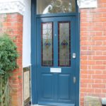 blue entrance door with decorate glass