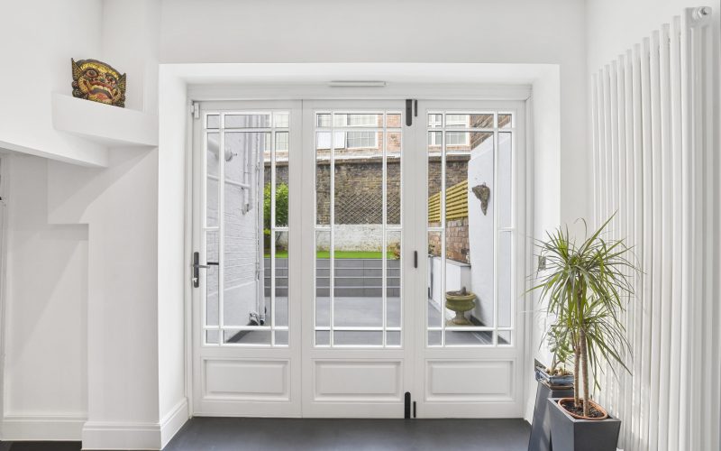 A timber bifold door with marginal glazing bars painted white