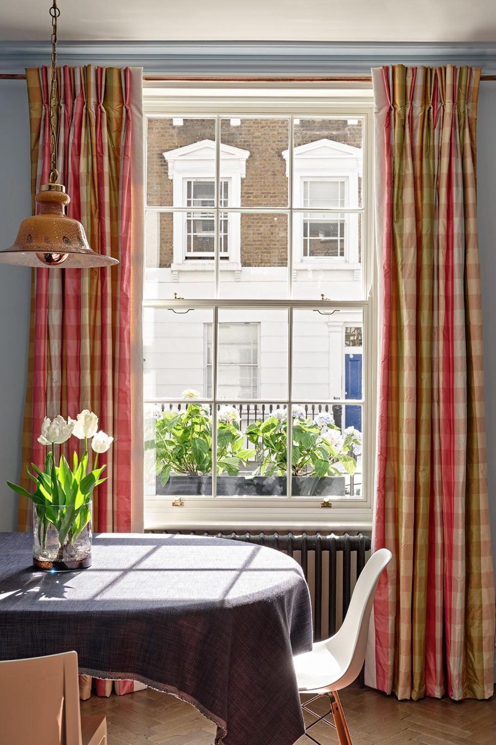 Timber window with curtains either side in Pimlico