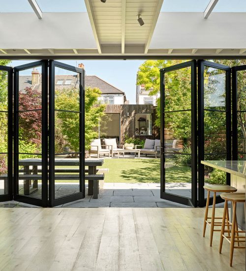 Large timber bifold doors which are partly open