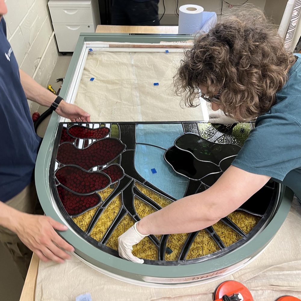 Put in stained glass into a timber frame window