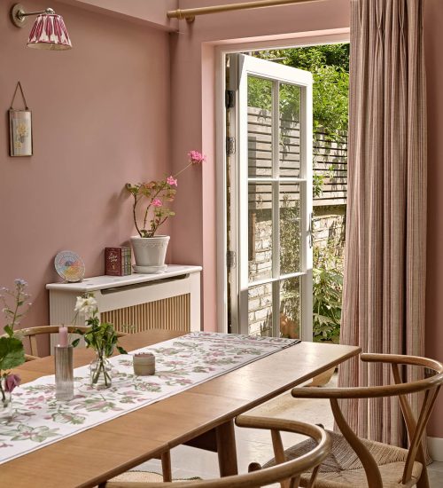 Pink dining room with an open timber glazed door