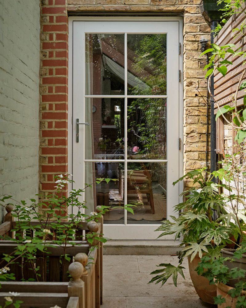 A timber door leading to a small patio