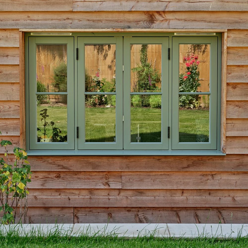 Timber casement windows surrounded by timber cladding