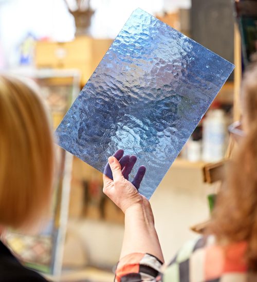 Sashed customer being shown some blue stained glass