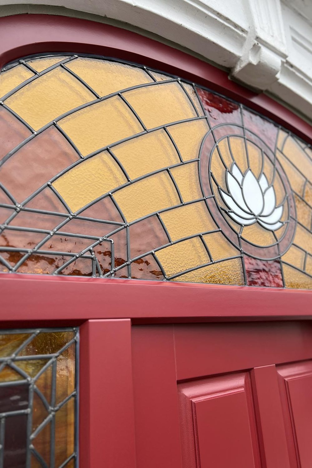 A timber entrance door made by Sashed with a white lotus in the stain glass