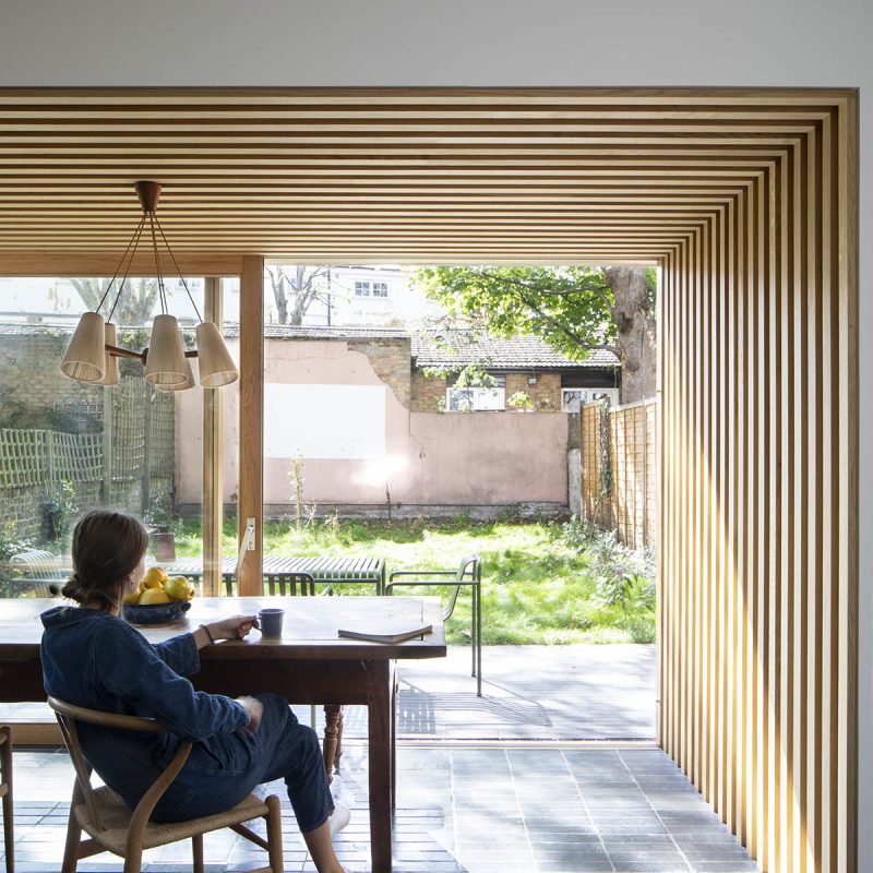 lady looking out some timber sliding patio doors