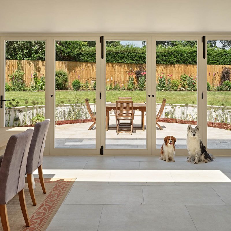 timber bifold doors with dogs in front