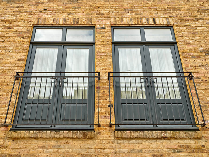 A sashed installation team installing wooden French doors