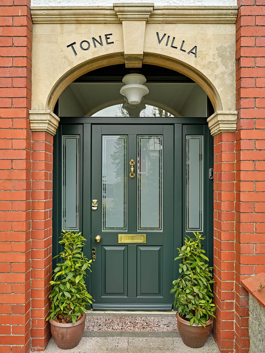 Bespoke timber entrance door with frosted glass in traditional building in London