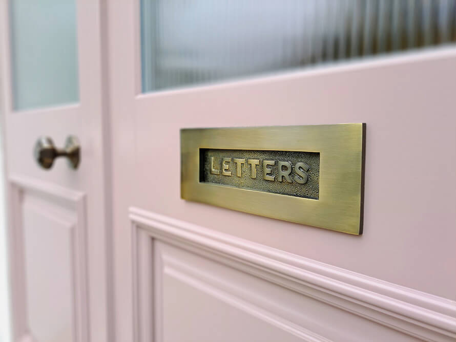 Wooden front with antique brass letter plate