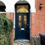 wooden entrance door with decorated glass view from outside