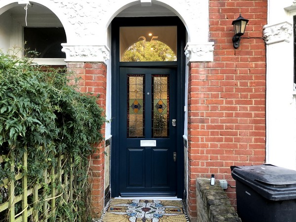 wooden entrance door with decorated glass view from outside