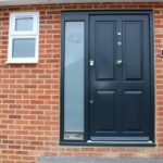 wooden entrance door outside view with brick wall