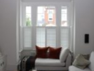 modern living room with large sash window in London property