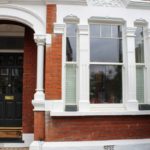 outside view of a traditional wooden sash window and entrance door